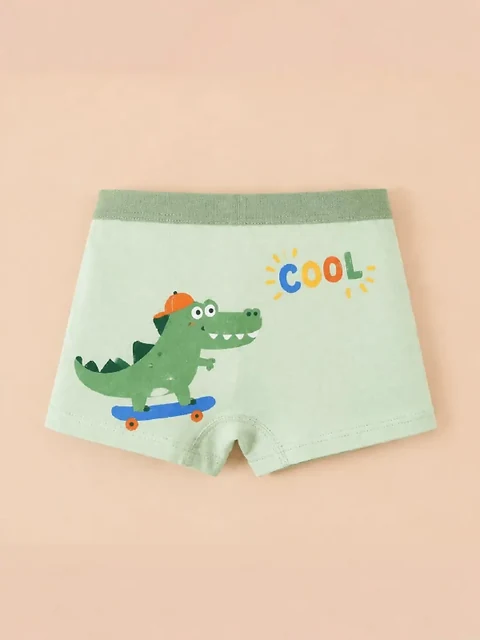 Grüne Boxershorts mit Dinosaurier auf einem Skateboard — ein Teil desselben vierteiligen Sets